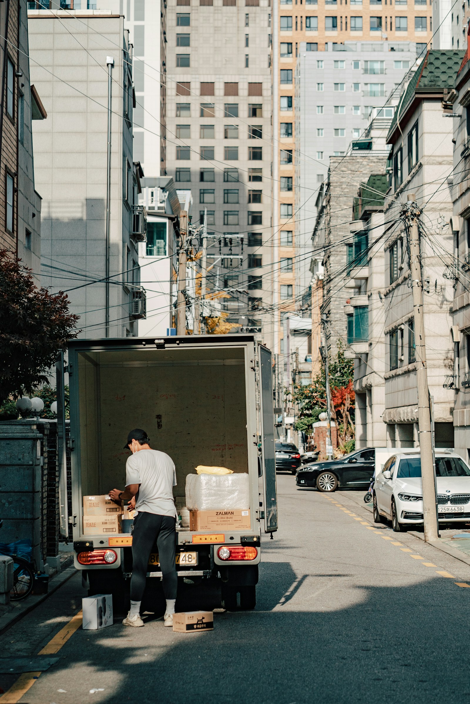 A mover carefully loading boxes into a truck